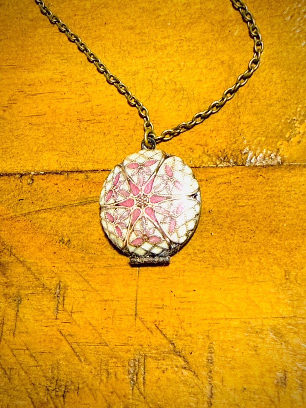 Vintage locket necklace with enamel floral mandala design in pastel and pink